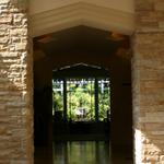 Entry looking through living room to fountain beyond.