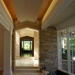 Gallery off the dining room with indoor-outdoor Koi pond, looking towards entry and living room beyond.  Fountain outside of living windows terminates formal axis.