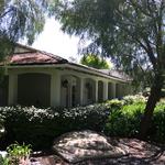 RHCA building:  Covered porches are a common element in Ranch style homes.  Porch roof provides for a low, horizontal character and also allows for higher interior walls and ceiling appropriate in scale to the room size.