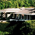 Designed in the late 80's this 7,500 sq. ft. home overlooks the South Bay through a pastoral canyon.  Glass contrasting against rhythmic stone pilaster supporting a stepping hipped roof.