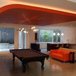 In the basement, the recreation room has a billiard area, with TV sitting area and bar beyond.  Windows into large light wells provide a great deal of natural light for a very enjoyable space.