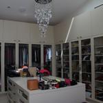 One of the master closets with wonderful natural light from both skylights and a window behind.