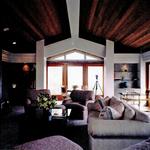 Family room with large bay window looking directly at coastline beyond.  This room was design and located  pre-construction to verify the sand and waves were framed in the bay.