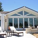 Great room with folding doors for indoor-outdoor living.  Note the glazing in the truss members above the doors.  Trusses are repeated as an interior element.