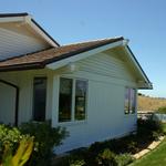 Custom siding, attic vent, and outlooker details. 